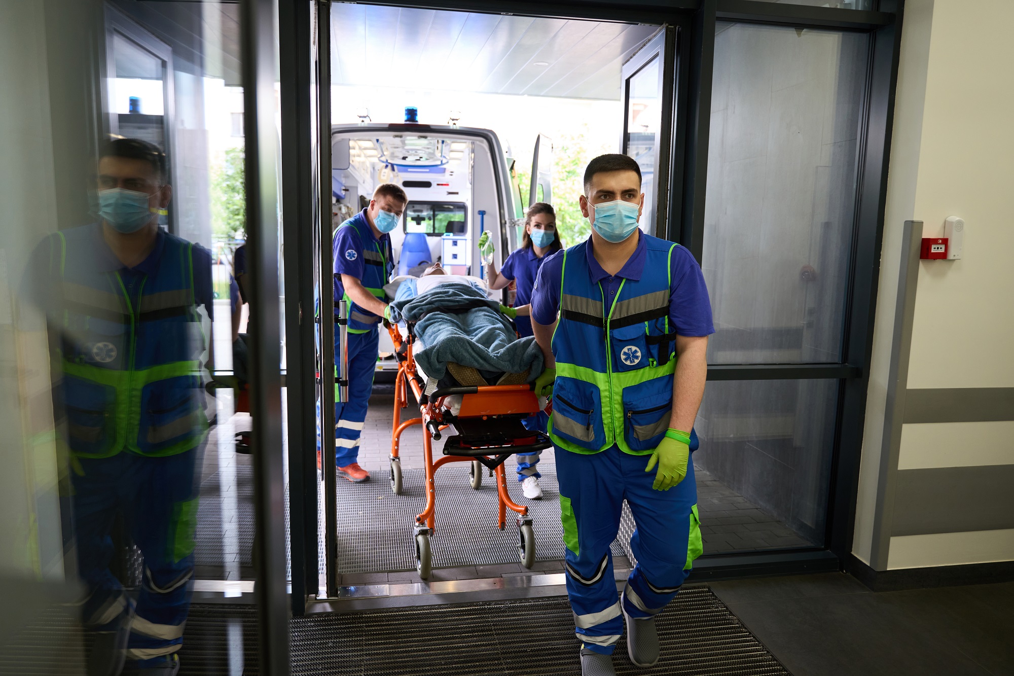Team of paramedics delivered gurney with patient to emergency room